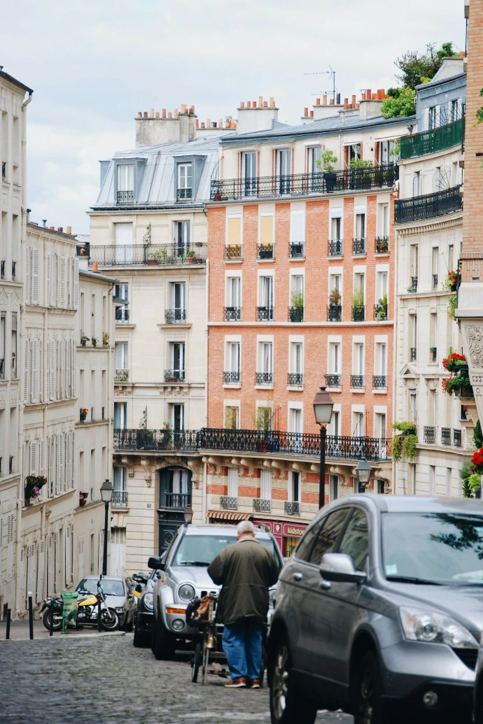man walking beside gray vehicle\